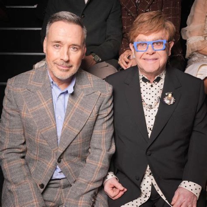 What does Elton John’s husband David Furnish do for a living?